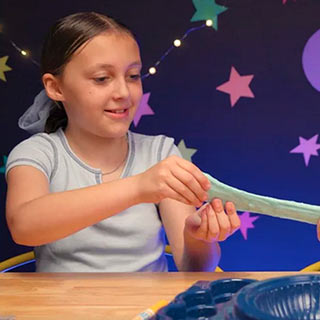 Young girl pulling Crayola Goo and stretching it